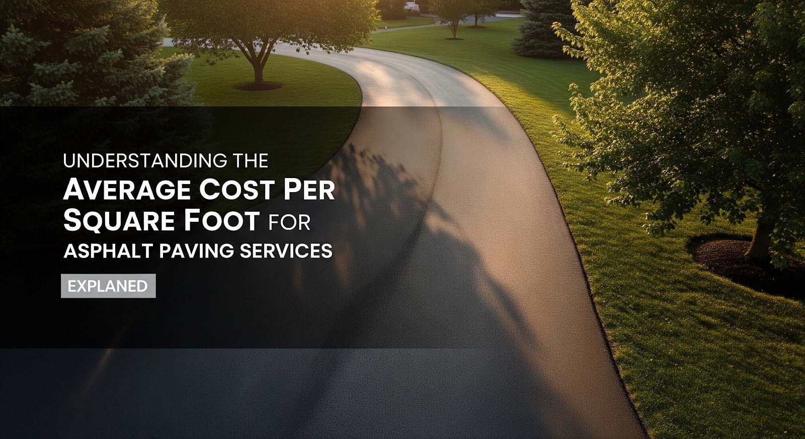 A smoothly paved asphalt driveway curves through a landscaped yard with lush green grass and trees, overlaid with text about understanding the average cost per square foot for asphalt paving services.